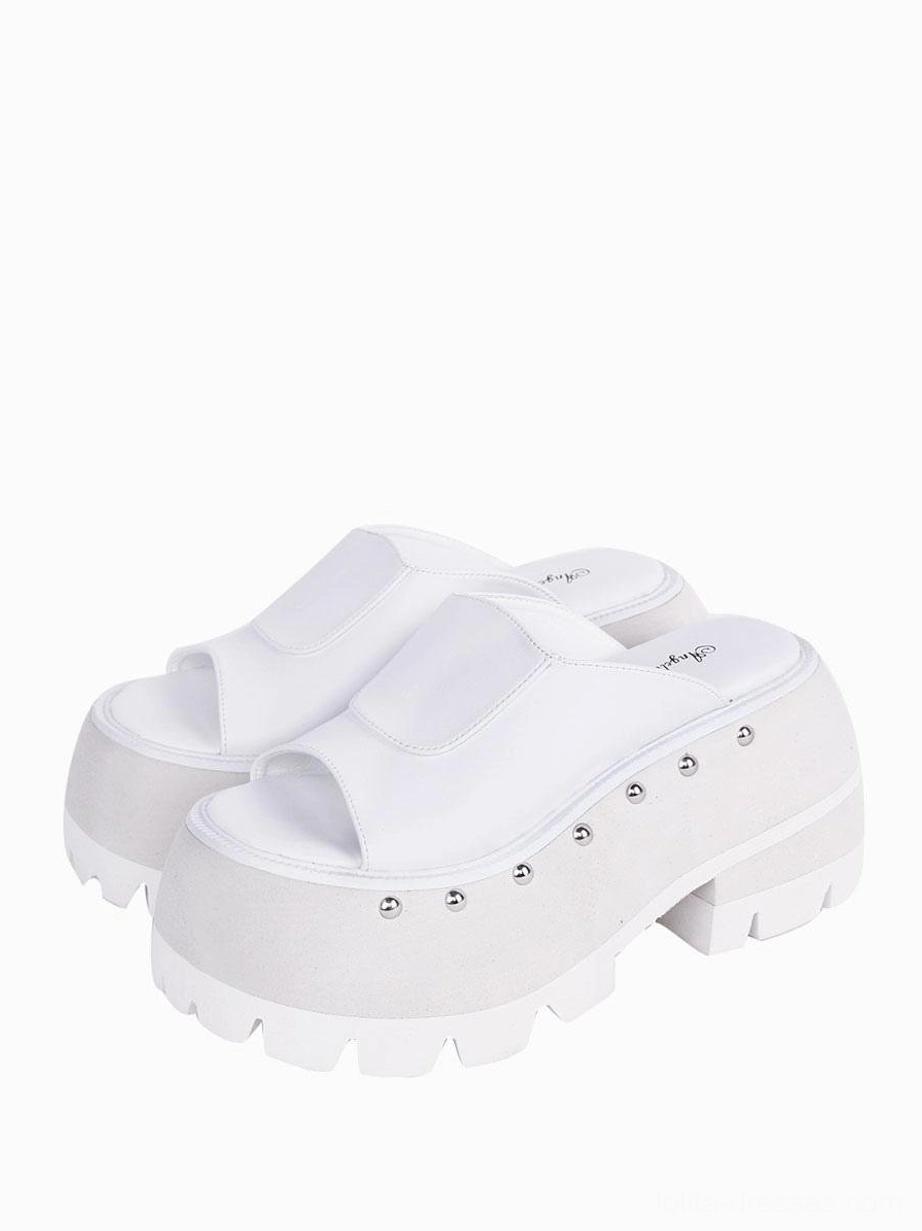 White Gothic Lolita platform sandals with silver rivet embellishments, three-quarter front angle displaying round toe design and architectural wedge platform
