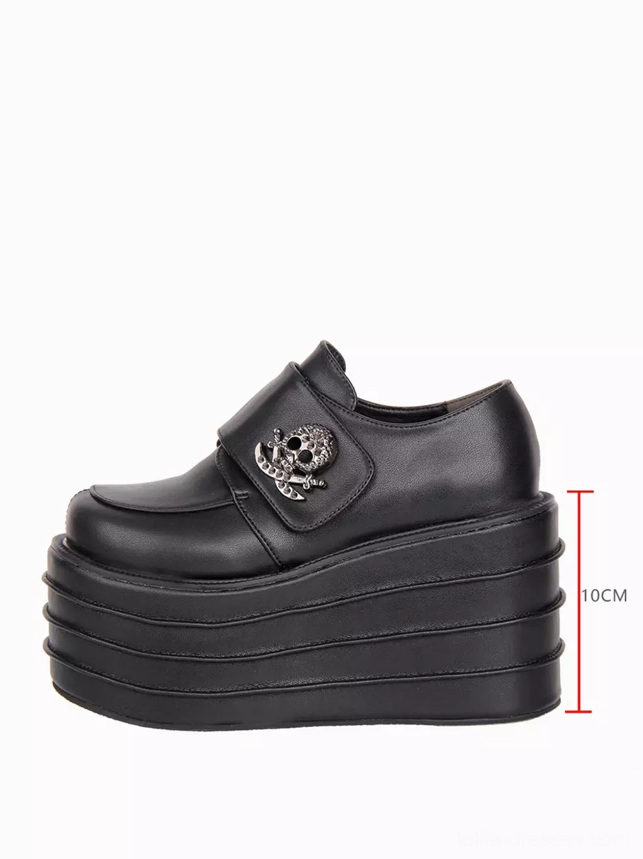 Single gothic lolita platform shoe right side profile with 10cm height scale marker showing layered wedge sole proportions, black PU upper, and skull metal badge detail