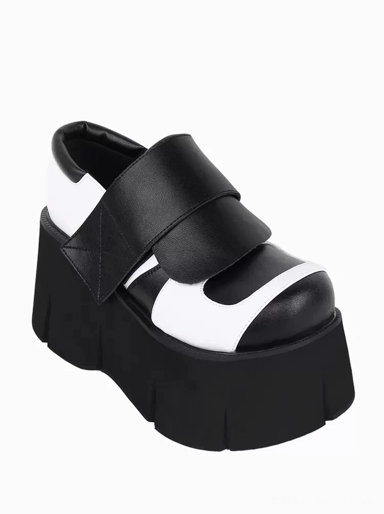 Gothic Lolita platform shoe left side front three-quarter view single shoe featuring round leather toe cap, wide velcro strap, and chunky textured outsole traction