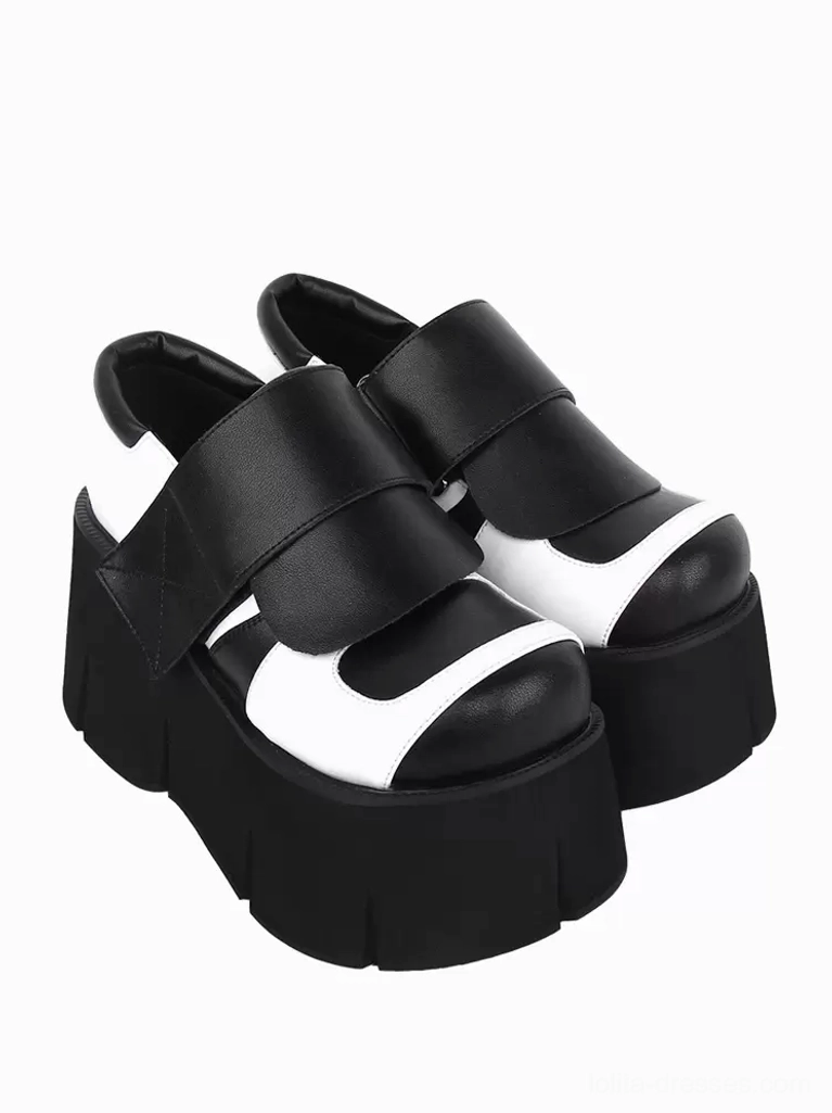 Gothic Lolita platform shoes back three-quarter view pair revealing closed heel construction, black-white two-tone color block, and ridged textured platform sole