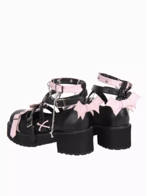 Gothic Lolita pumps rear view showing bat wing heel decorations black leather with pink trim and cross strap details