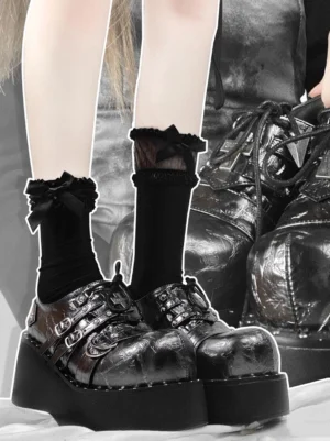 Black gothic lolita platform shoes front view with metallic PU leather and double buckle straps styled with ruffled black socks