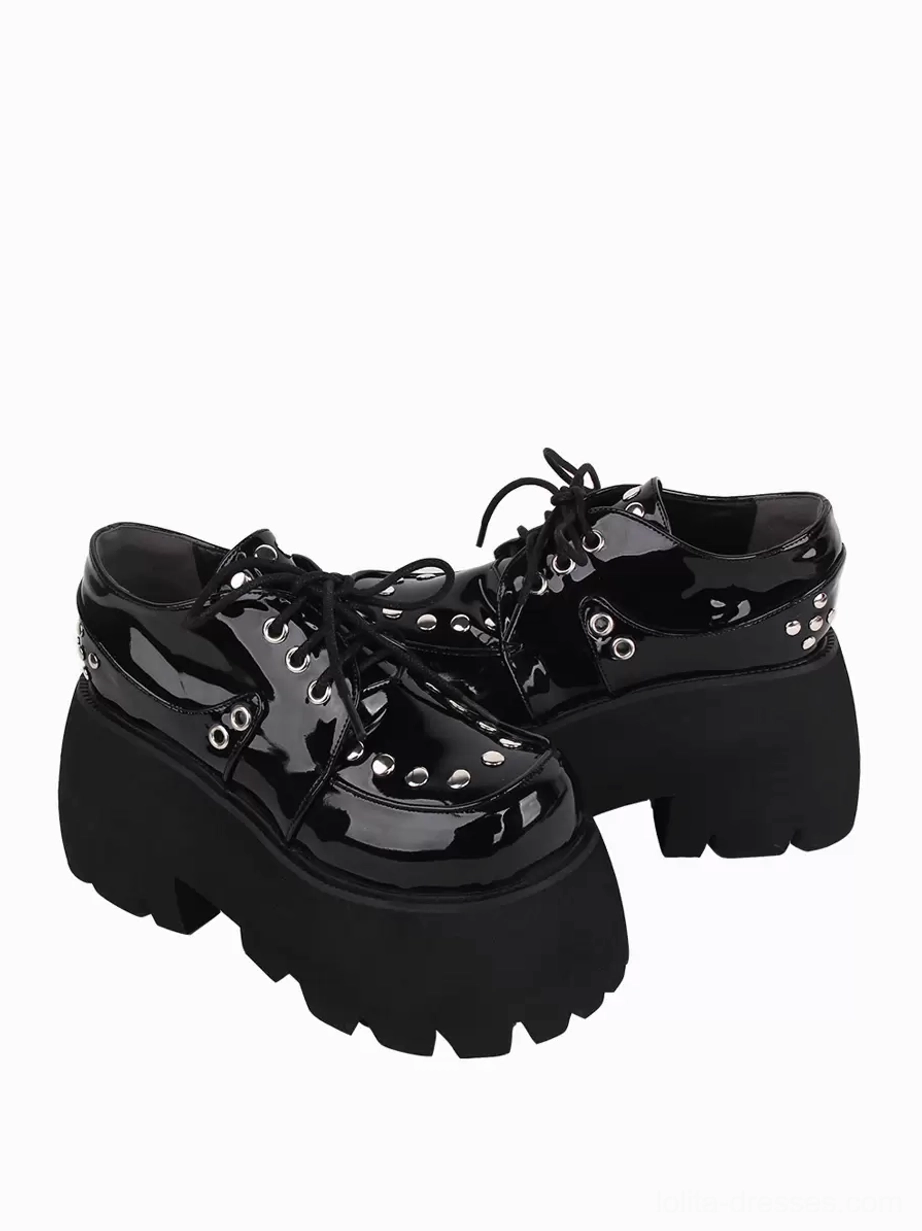 Rear three-quarter view of black Gothic Lolita platform shoes displaying heel rivets, chunky platform construction, and back heel profile