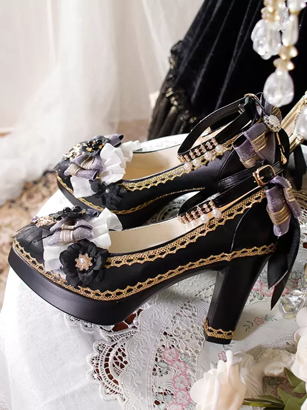 Side profile view of Gothic Lolita platform high heels on lace tabletop showing chunky block heel structure and dark gray-purple fabric bow embellishments
