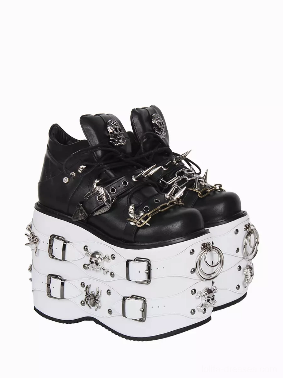 Paired Gothic Lolita platform shoes front close three-quarter view black upper with skull logo on heel collar white sole with metal ring buckle and skull decorations