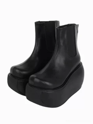 Gothic lolita black platform wedge boots with square toe three-quarter front view showing thick sole and elastic side panels