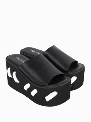 Paired black lolita platform slide sandals side view displaying single strap design decorative cutouts on thick wedge sole and open toe construction