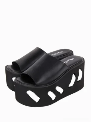 Black gothic lolita platform wedge sandals with geometric cutout pattern front three-quarter view showing matte PU upper and sculptural sole design