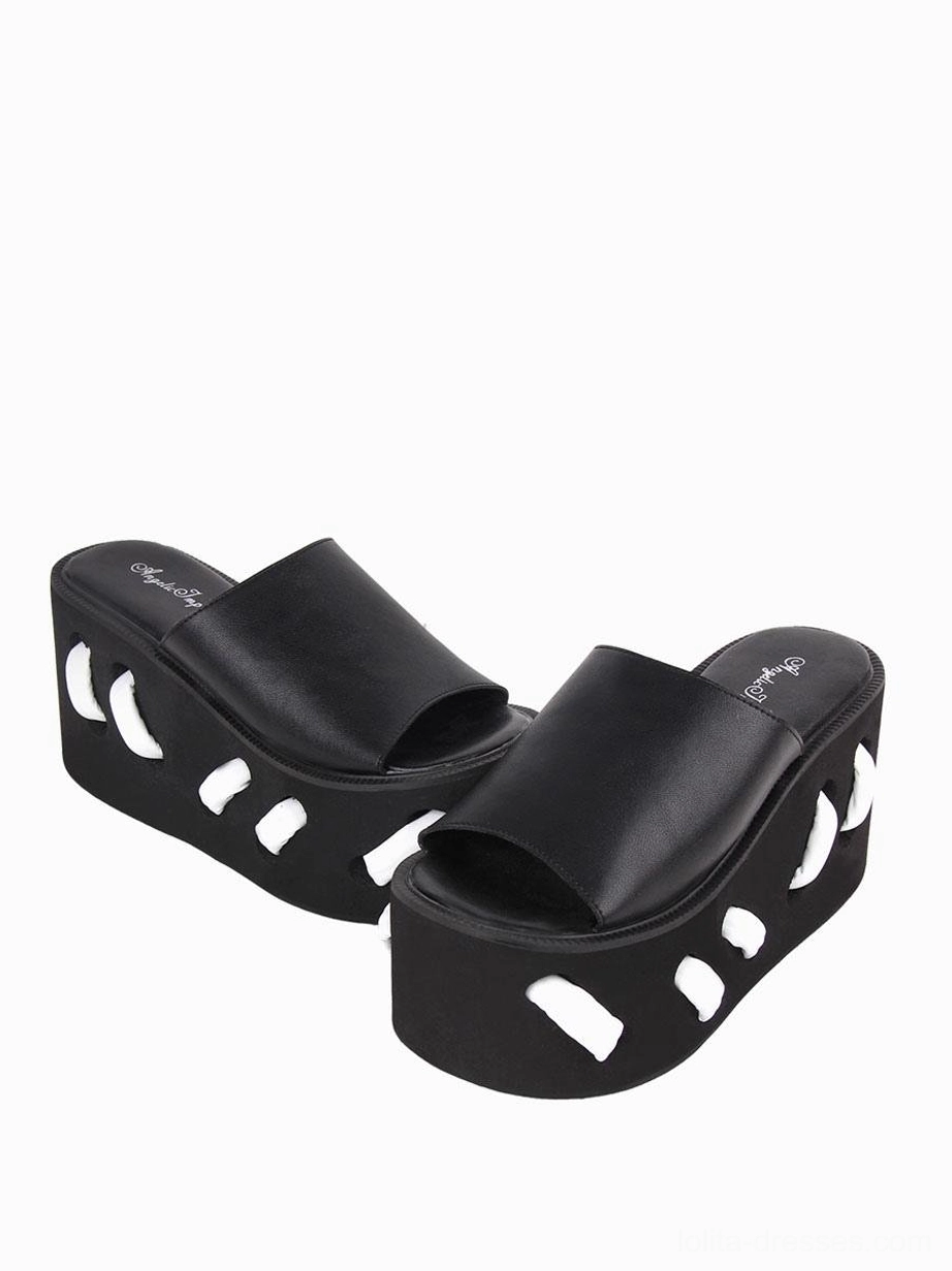 Dual side profile view of black lolita platform sandals showing wide single upper strap small cutouts on both sole sides and structural wedge design