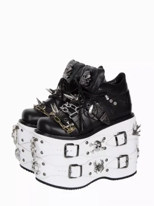 Gothic Lolita platform wedge shoes with metal chain and spike details front three-quarter view showing black PU leather upper and white sole with skull and spider motifs paired display