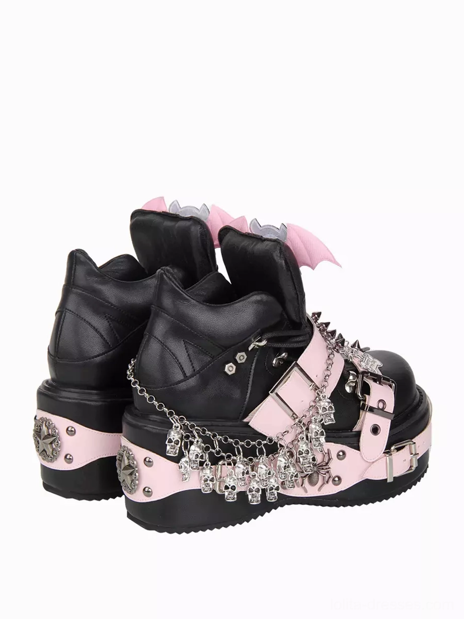 Black gothic lolita platform wedge shoes rear paired three-quarter view showing hanging skull chain ornaments and thick wedge sole construction