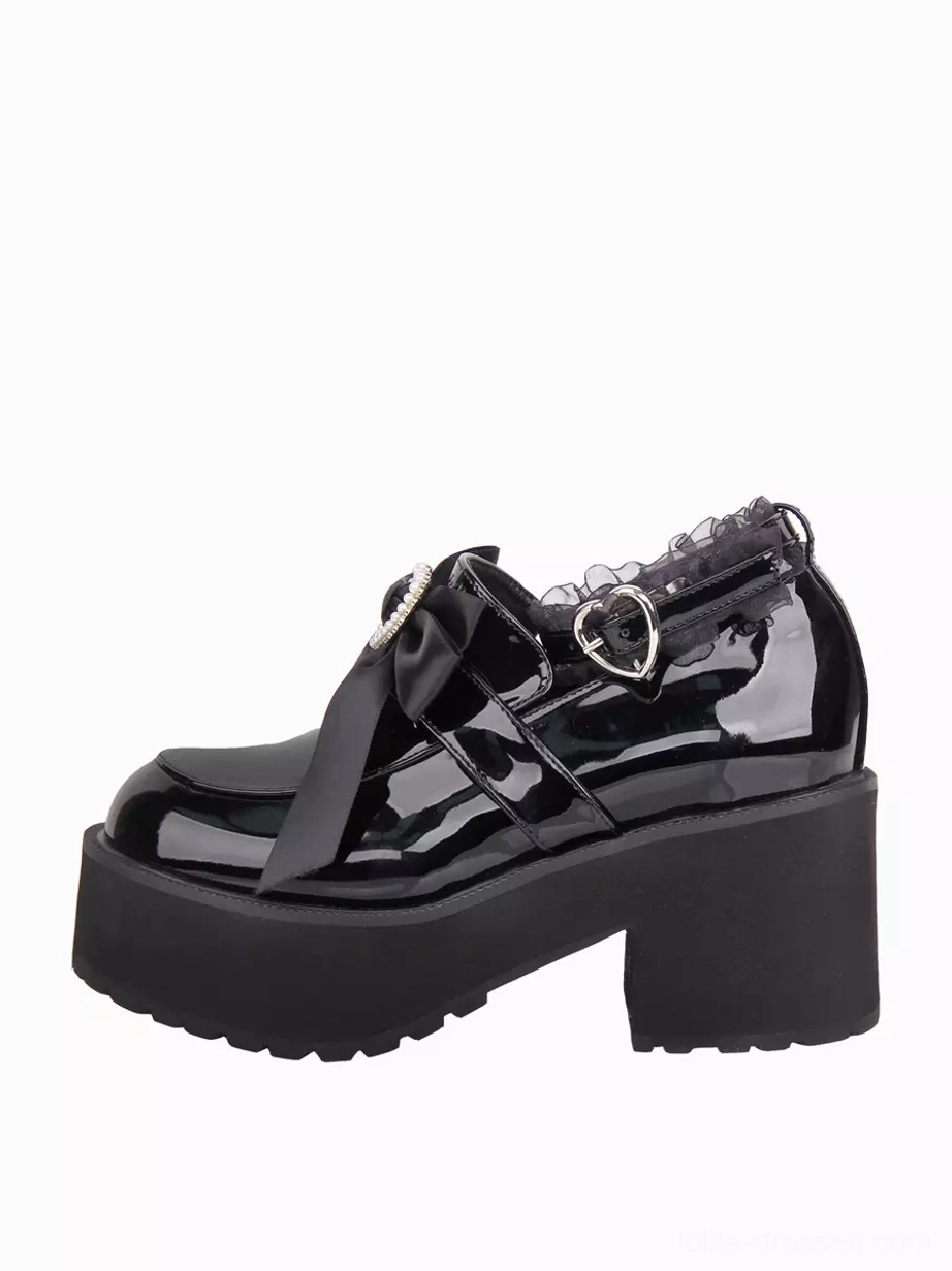 Side three-quarter view of single black gothic lolita pump showcasing thick platform sole, ruffle lace ankle strap trim, and patent leather glossy finish