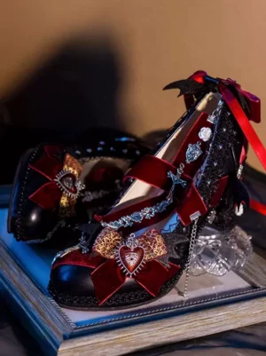 Gothic lolita high heel pump with wine red bow and heart pendant, black glitter upper with bat wing heel decoration, three-quarter side view