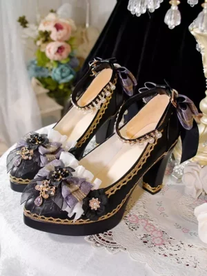 Gothic Lolita pumps flat lay overhead view showing black upper with golden edge trim and dark blue mesh bow details against velvet dress and floral background