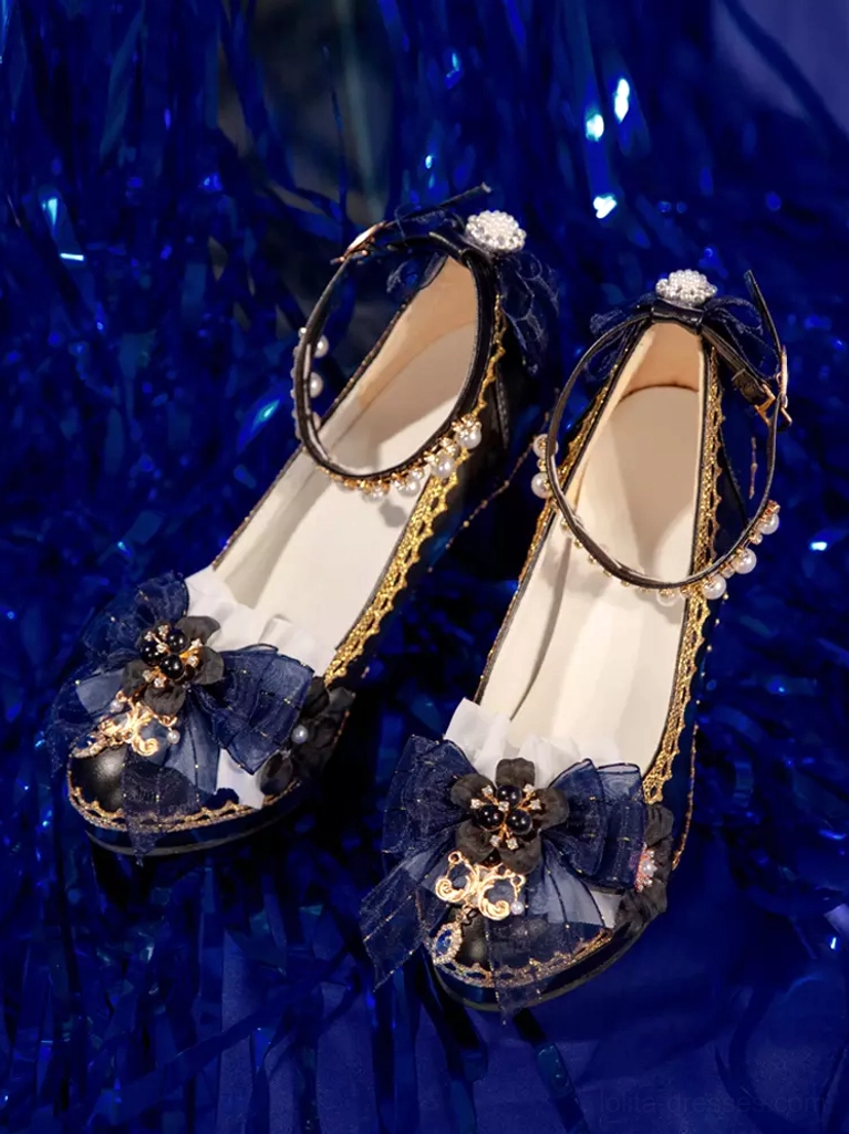 Glamorous flat lay overhead shot Gothic Lolita pumps against shiny blue tinsel background with dark blue bows jeweled decorations classic black-gold aesthetic