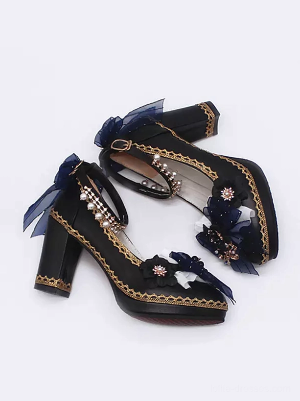 Overhead flat lay view Gothic Lolita pumps tilted position showing black upper with dark blue mesh bow jewel ornament decorations and classic black-gold color scheme