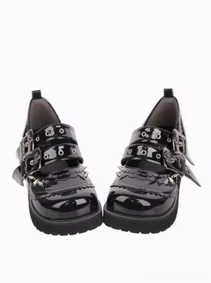 Pair of black gothic lolita chunky heel pumps with round toe and thick platform sole, front-on flat view showing double buckle strap system and high-gloss black PU leather surface against white background