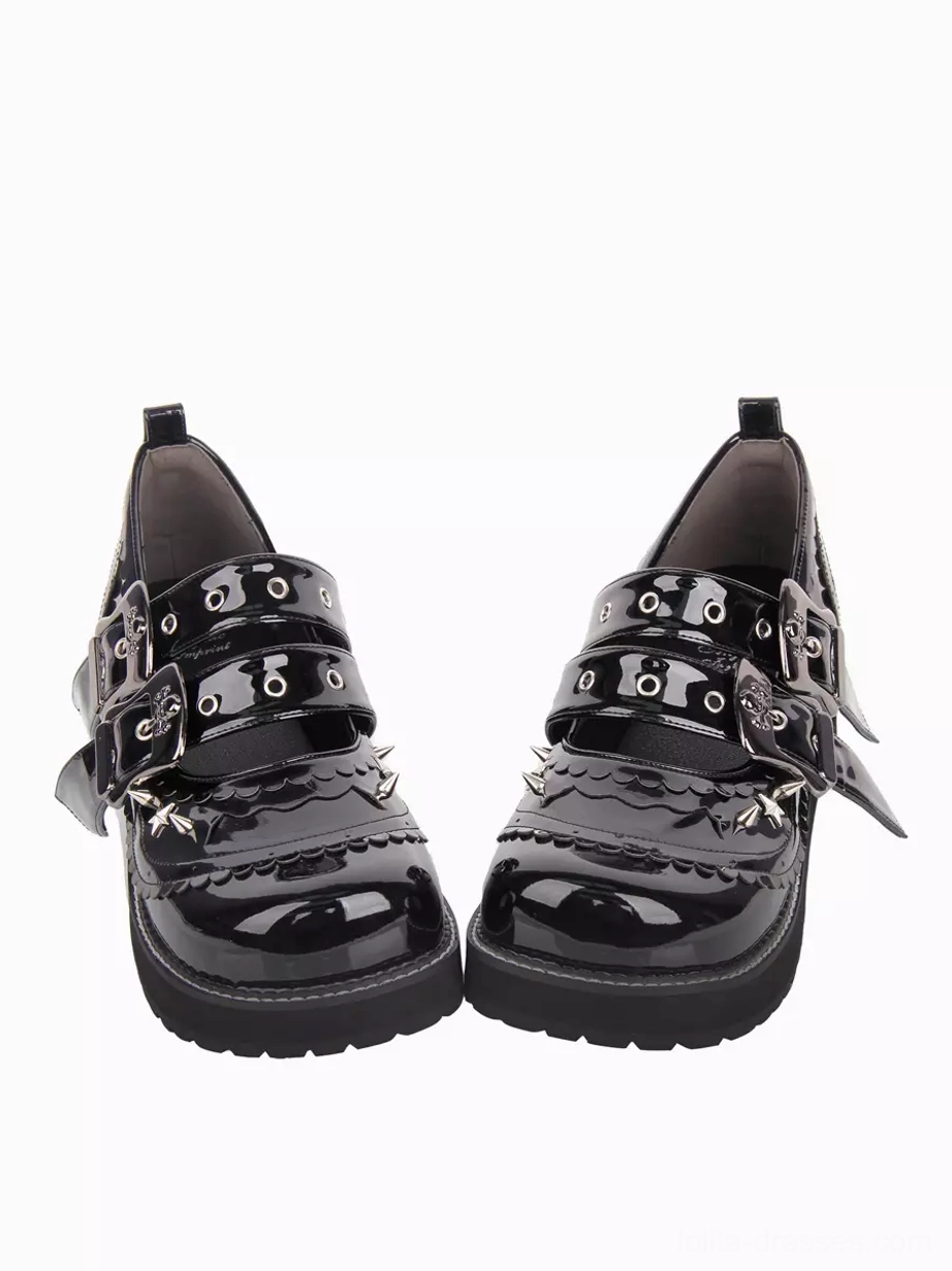 Pair of black gothic lolita chunky heel pumps with round toe and thick platform sole, front-on flat view showing double buckle strap system and high-gloss black PU leather surface against white background