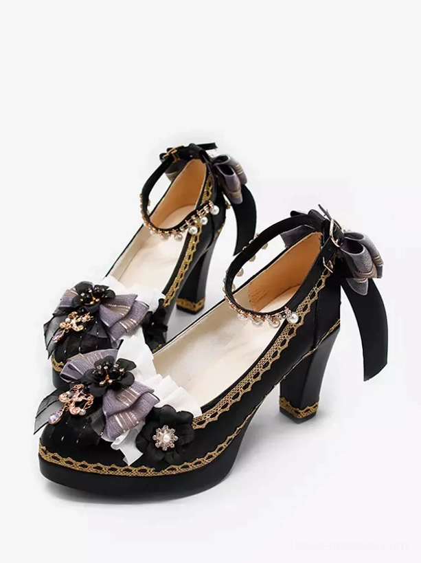 Three-quarter side angle of Gothic Lolita pointed-toe pumps with black upper golden trim jewel charms and prominent back ankle strap fabric bow on white background