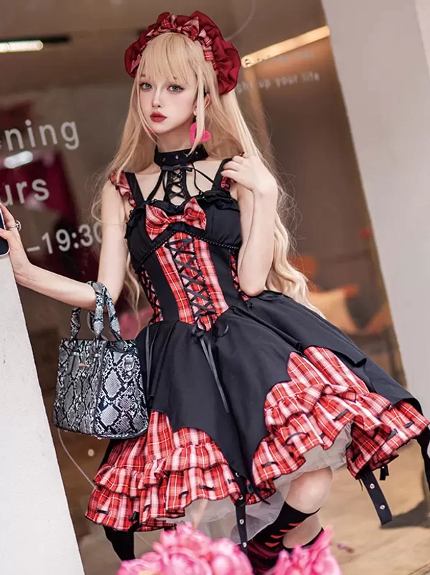 Red plaid Gothic Lolita dress on model with fishnet stockings and snake-patterned handbag, standing outdoor coordinate