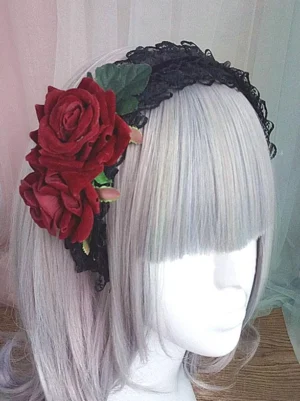 Gothic Lolita rose lace headband with black ruffled band and wine-red artificial roses, three-quarter view on mannequin with silver wig, featuring green leaves and delicate flower buds