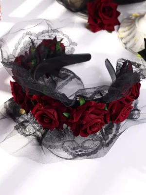 Flat lay product photography of gothic lolita headband with clustered wine red artificial roses, black tulle and lace trim details, plastic headband base overhead view