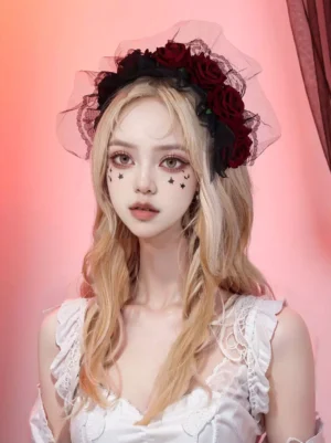 Gothic lolita rose veil headpiece worn by model with black lace tulle and wine red artificial roses, front portrait view with star eye makeup on pink gradient background