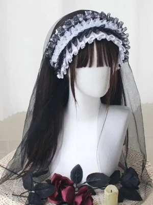Ruffled black and white lace Gothic Lolita headband with dramatic black tulle veil, front three-quarter view on mannequin with rose decoration