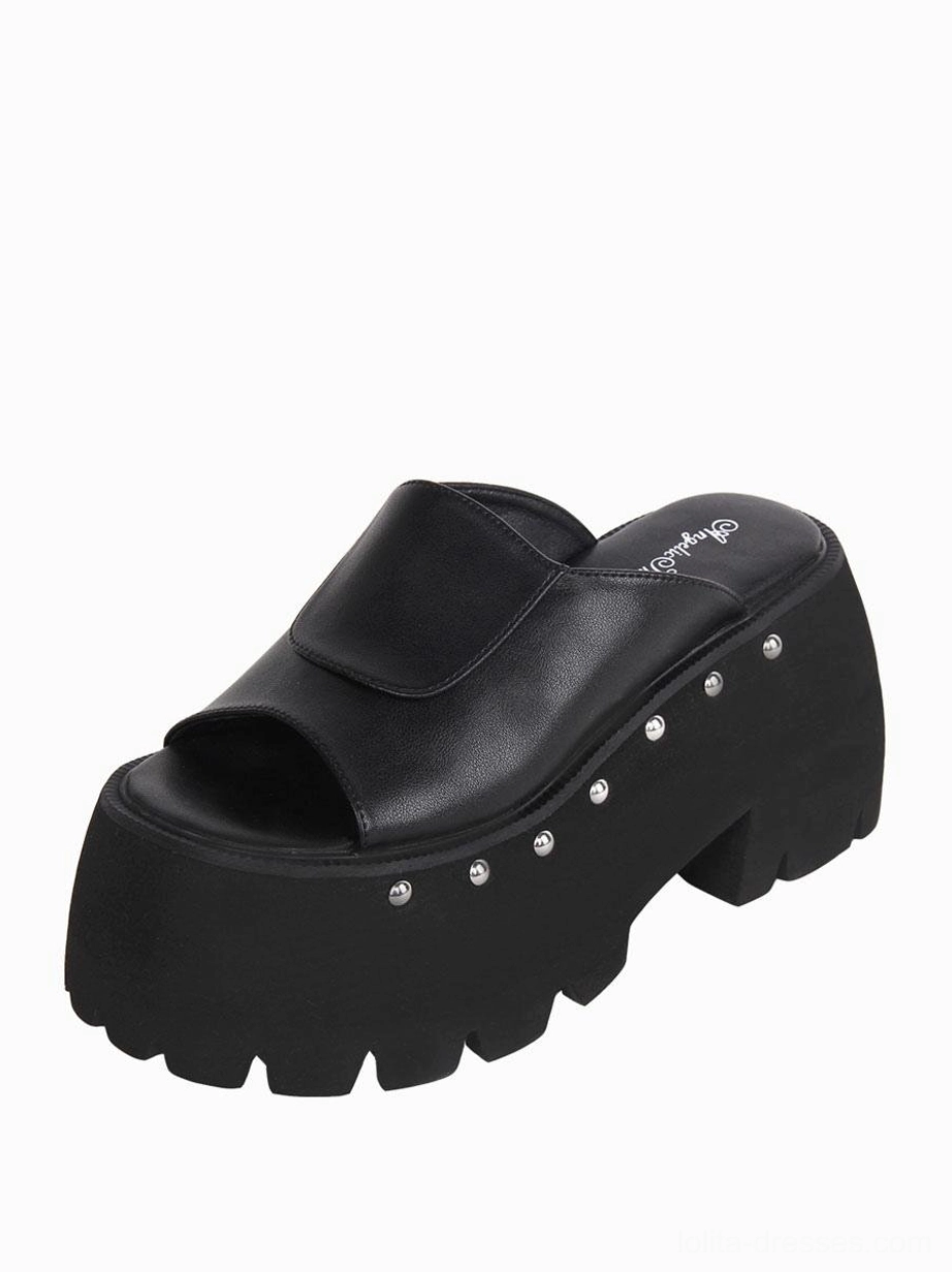 Single black Gothic Lolita platform sandal side view highlighting the 3.9-inch wedge heel, PU leather construction, and silver rivet trim placement