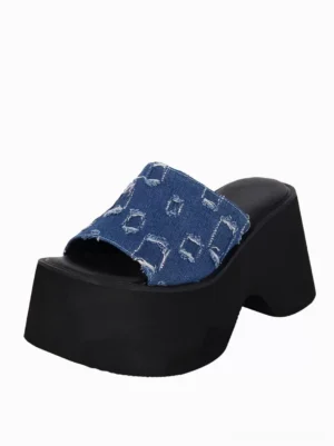 Single blue denim distressed Lolita mule sandal side three-quarter view revealing woven texture thick block heel platform construction