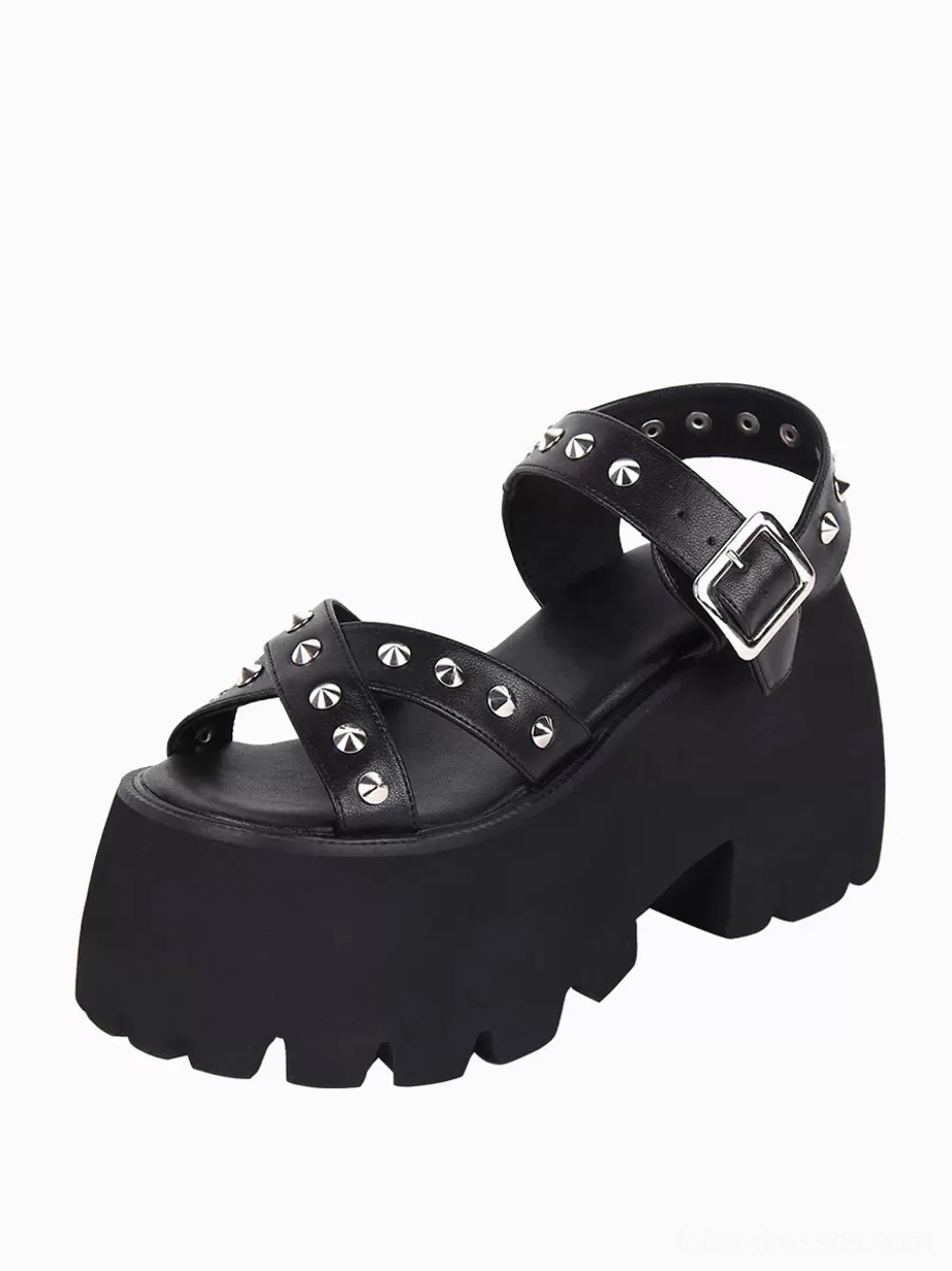 Black Gothic Lolita platform sandal front three-quarter angle showcasing complete crisscross peep toe design with silver pyramid studs and chunky lug platform foundation