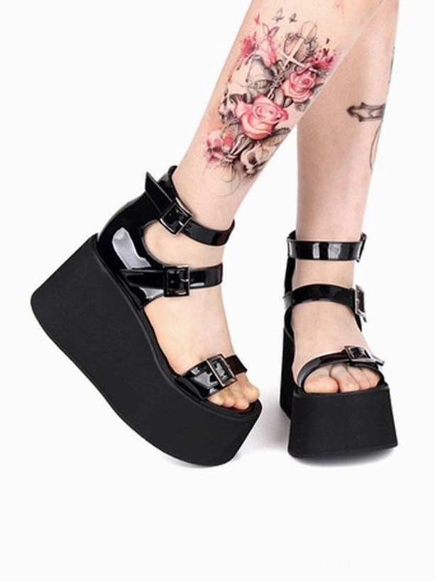 Gothic lolita summer sandals double feet side view showing model legs wearing black platform shoes with multiple buckle fastenings, matte black wedge platform, patent leather upper, open round toe silhouette