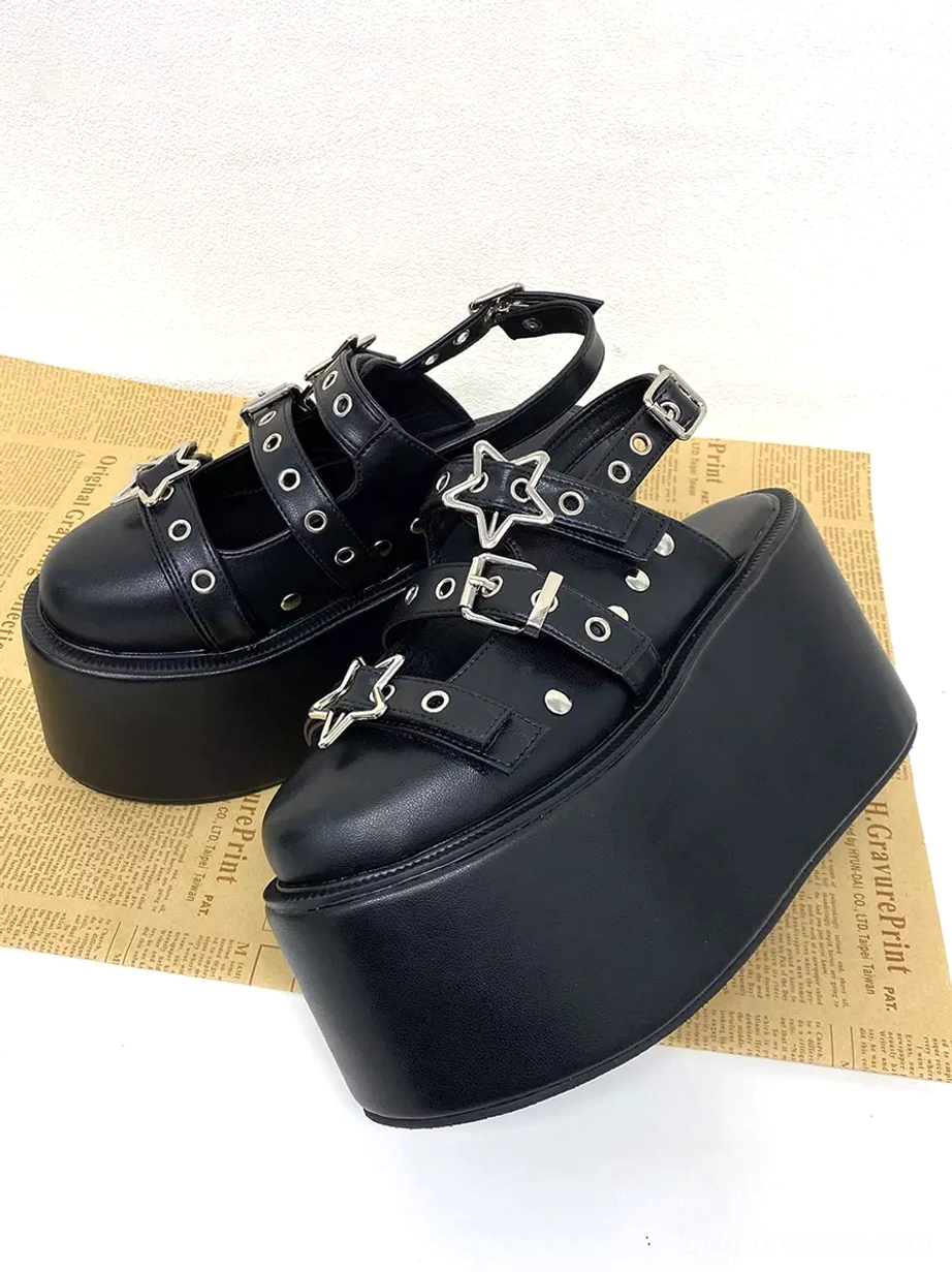 Pair of black gothic lolita platform sandals low side angle showing thick wedge sole silver stud accents and adjustable ankle buckle