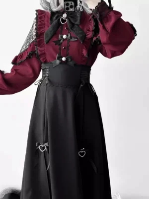 Gothic lolita set detail shot showing corset-style waistband with pearl buttons, lace trims, and black bow accents on the wine red and black coordinated ensemble
