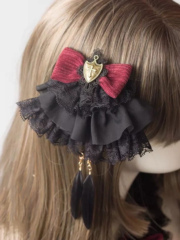 Gothic lolita side hair clip with wine red bow and black lace ruffle on mannequin, rear angle close-up view showing metal shield charm and feather pendant details