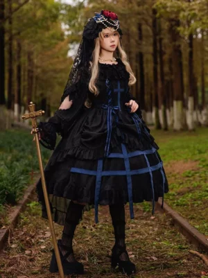Gothic Lolita sleeveless jumper dress styled with long lace sleeves and platform heels, deep blue color variant front oblique angle view on model in forest railway outdoor scene