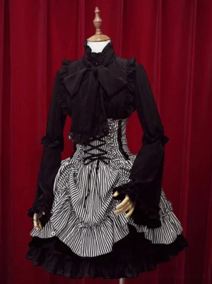 Gothic lolita black and white striped skirt with high waist, front three-quarter styling showing black ruffled long sleeve top coordination with big bow and striped lace-up corset skirt