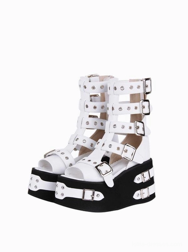 Pair of Gothic Lolita platform gladiator sandals front three-quarter view with white upper straps, silver buckles, black soles featuring decorative silver straps and studs