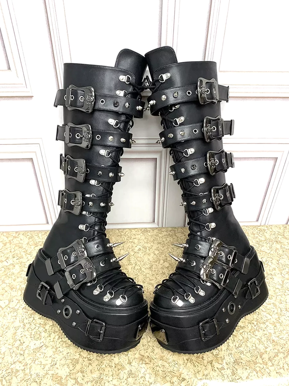 Side oblique view of black Gothic Lolita tall platform boots featuring multiple buckle straps, studded details, lace-up front, and thick platform sole construction