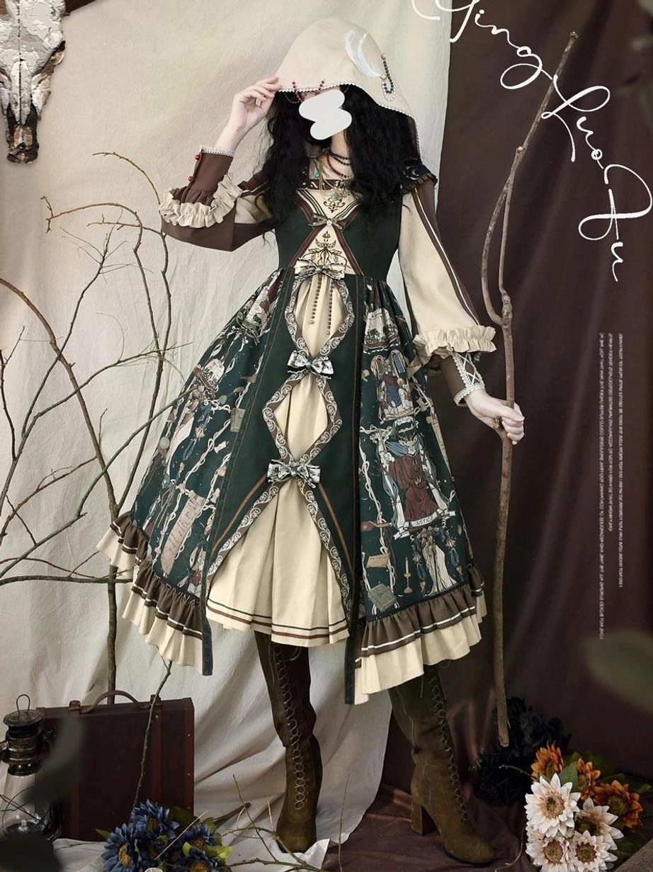 Gothic lolita model wearing dark green hooded dress with tarot print brown boots bonnet walking stick vintage aesthetic