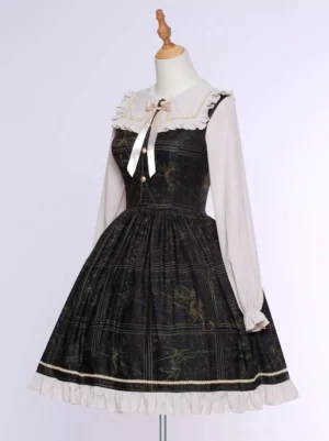 Three-quarter side view of gothic lolita chiffon dress with long sleeves, ruffled hem trim, and delicate gold pattern details on dress form