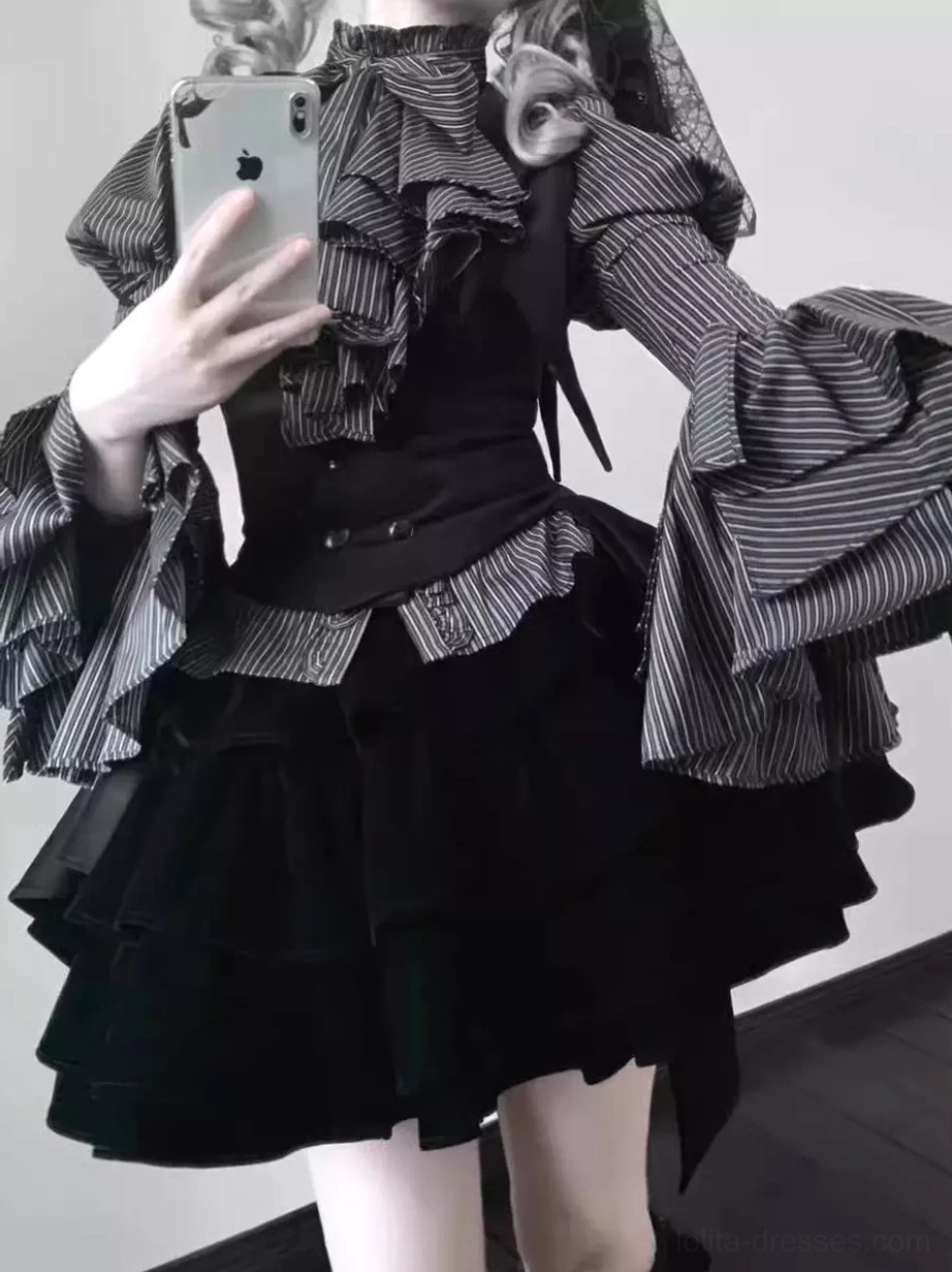 Front mirror selfie view of Gothic Lolita 3-piece set showing high neck ruffled blouse, black fitted waistcoat, and black layered mini skirt with modern styling