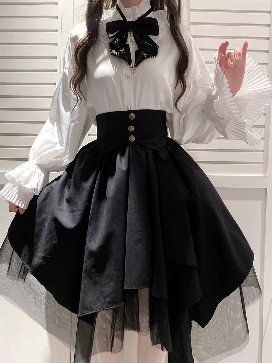 Black gothic lolita tiered skirt flat lay front view showing complete coordinate with ruffled white blouse black bow necktie and asymmetrical layered hem detail
