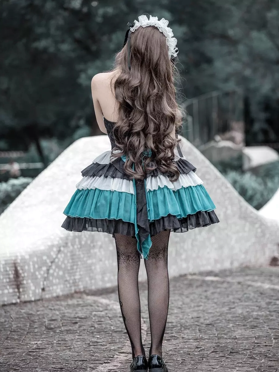 Gothic Lolita tiered ruffle dress back full-body view model with long wavy hair maid accessory outdoor