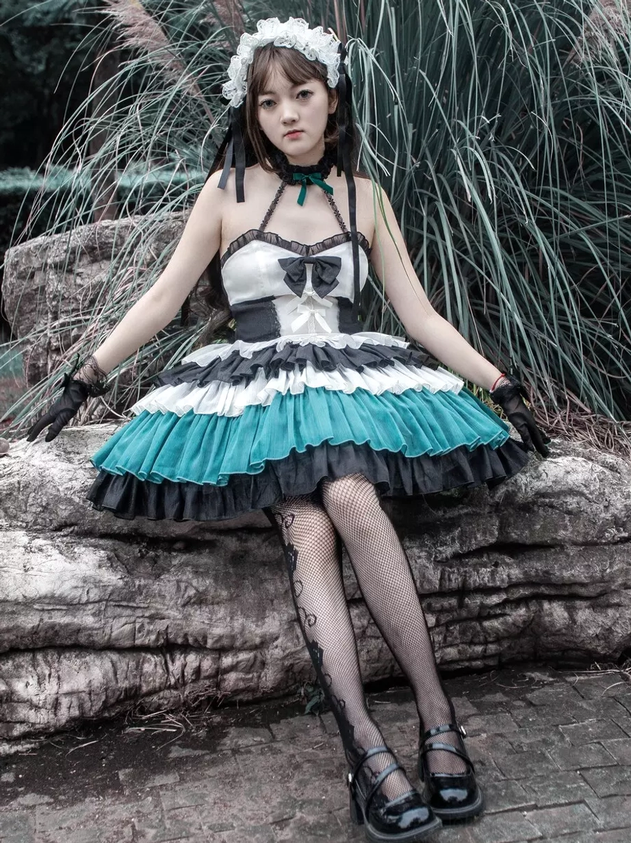 Gothic Lolita tiered ruffle dress sitting pose outdoor scene female model wearing fishnet stockings