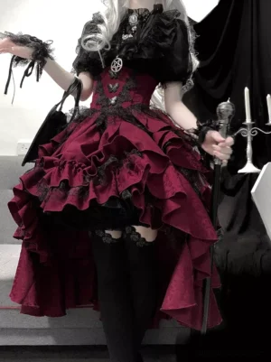 Gothic lolita two-piece outfit featuring black lace short-sleeve blouse with jacquard pattern and wine-red tiered ruffled high-low skirt, front three-quarter full view on silver-wigged model in dark studio
