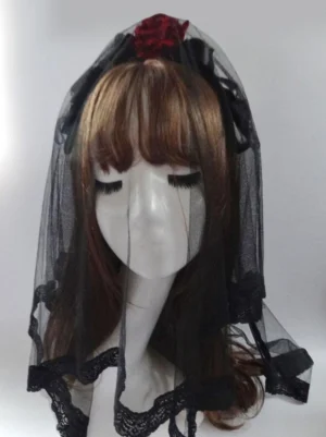 Gothic Lolita veil headdress front three-quarter view with black tulle scalloped lace trim and red rose decoration on brown mannequin head