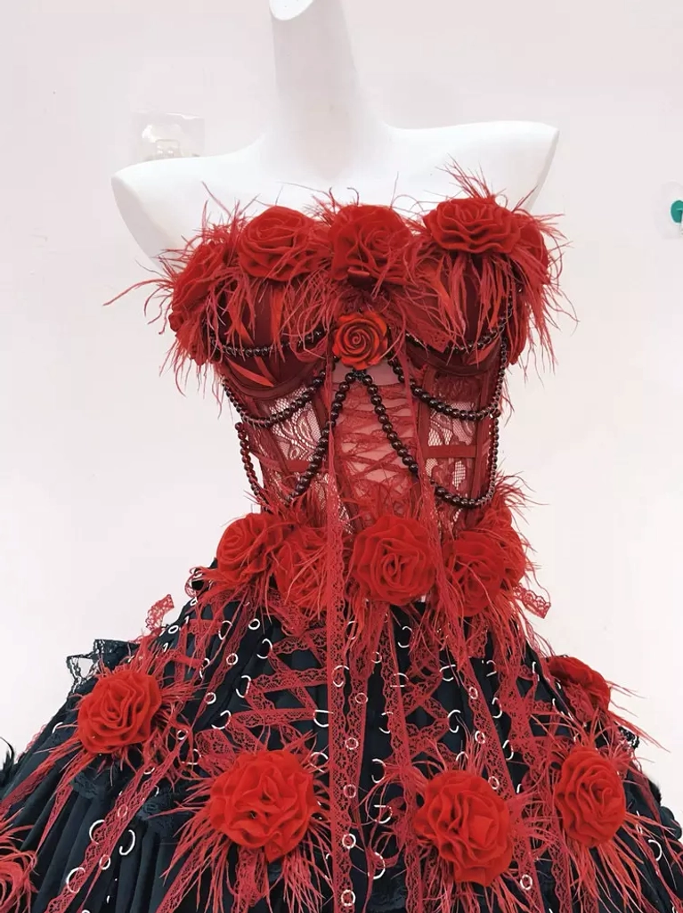 Gothic lolita dress set close-up detail of sheer mesh corset bustier with beaded chains and red rose flower feather trims showing intricate craftsmanship