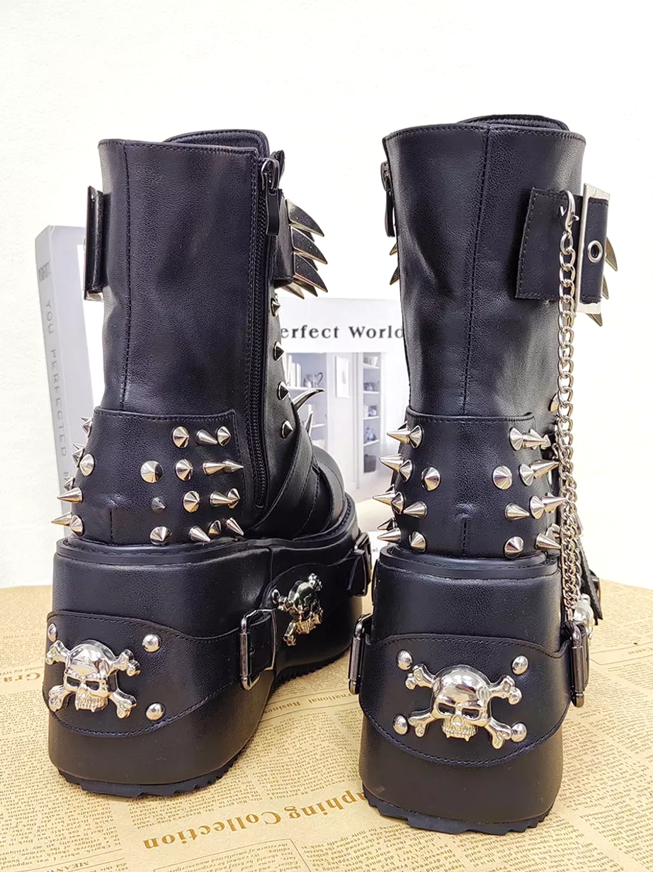Rear oblique view of black gothic boots showing skull heel pattern side zipper and chain metal details