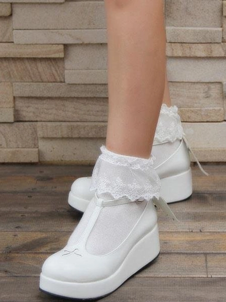White Gothic Lolita platform Mary Jane shoes side partial model view T-strap cross toe cap thick platform stone tile wall setting